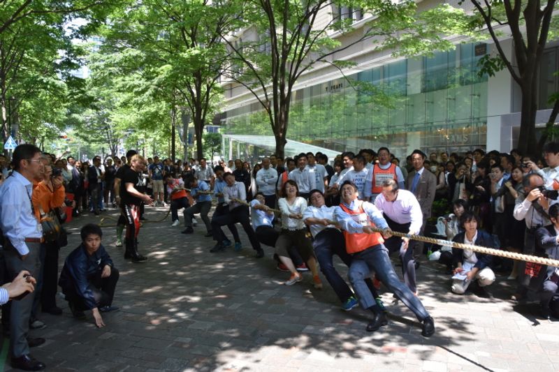 Tokyo's besuited office workers play tug of war on the streets of Marunouchi, Tokyo photo