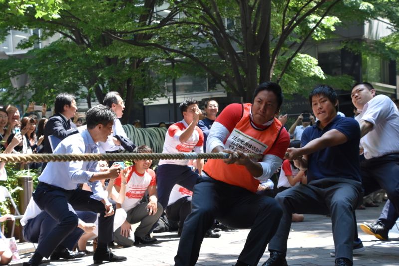 Tokyo's besuited office workers play tug of war on the streets of Marunouchi, Tokyo photo